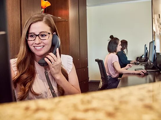 Friendly receptionist provides expert call handling while team delivers admin support in Servcorp’s modern office hub.