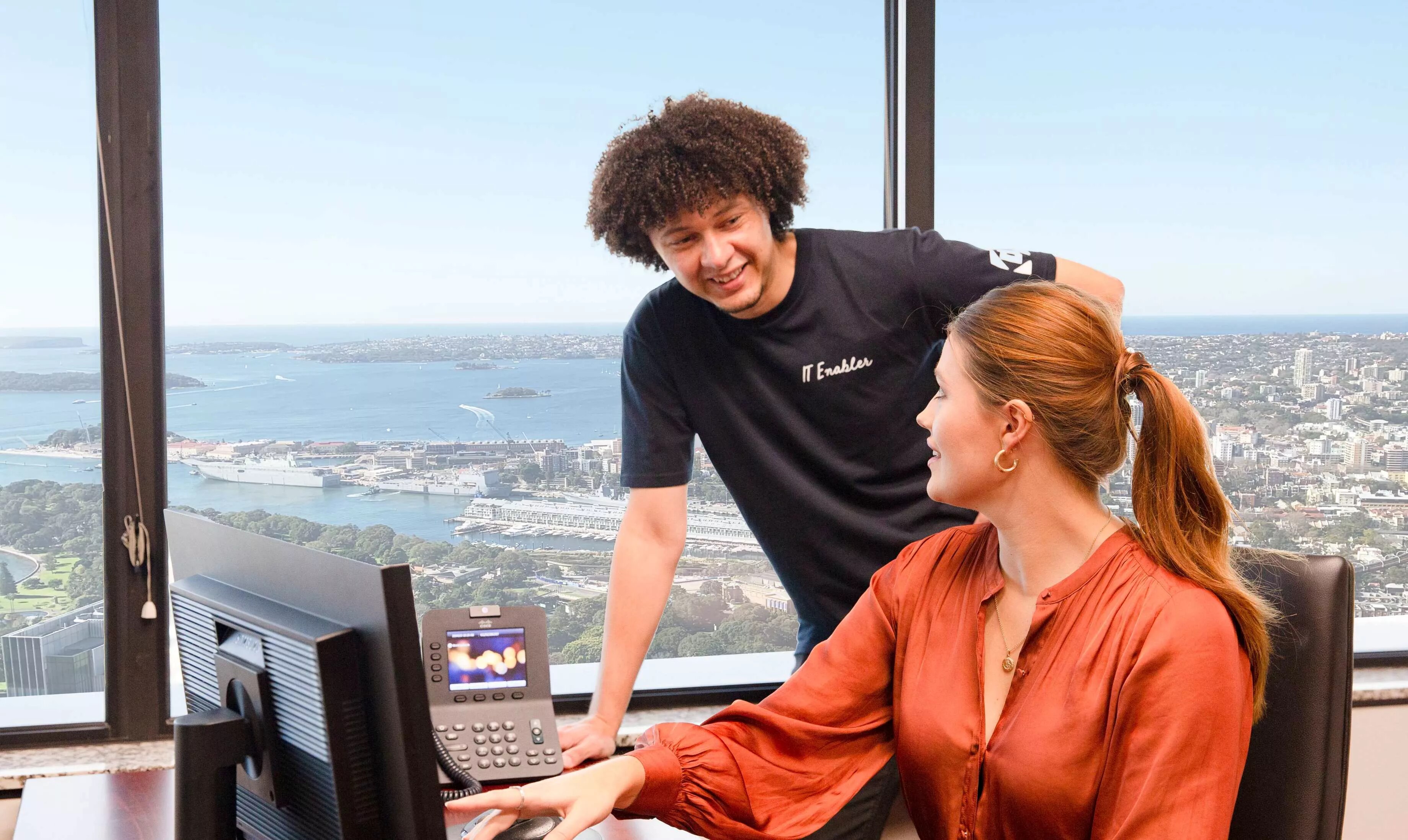 Servcorp IT assists a client in a serviced office with a stunning view over the city skyline.