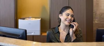 A dedicated receptionist from North Wacker, Chicago, at ready to assist the inquiries.