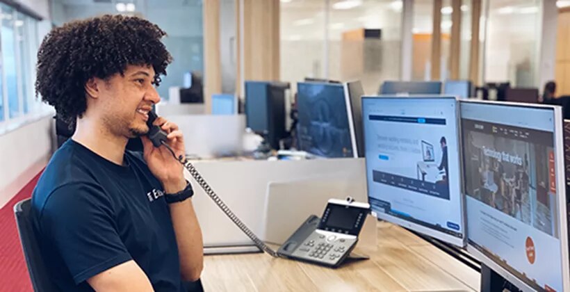 Premium coworking space at 17 State Street, New York, where professional staff handle client calls with care and efficiency.