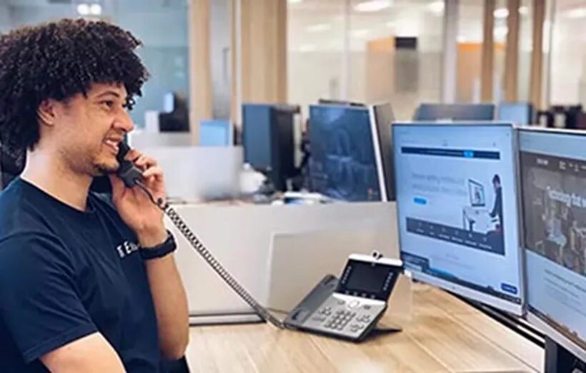 Coworking space at 155 North Wacker, Chicago, where a man is professionally responding to client inquiries.